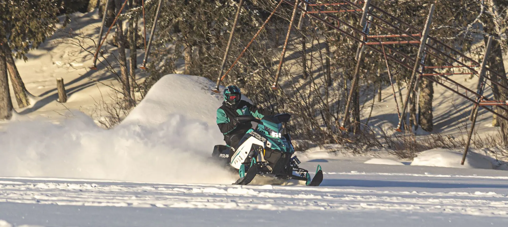 polaris indy xcr snowmobile throwing snow on a trail