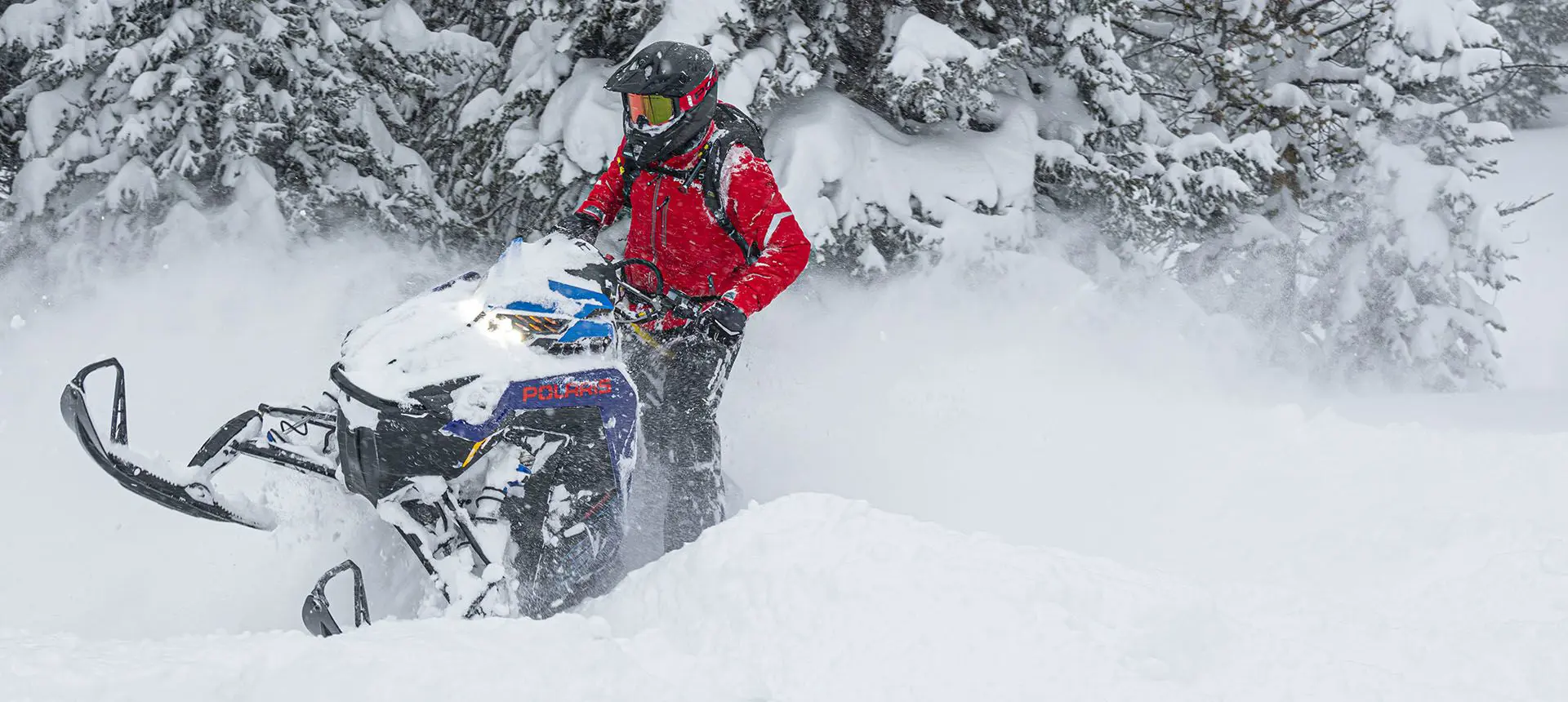 rider powering through deep snow on a polaris pro rmk slash snowmobile