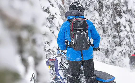rider overlooking terrain with his polaris pro rmk slash snowmobile