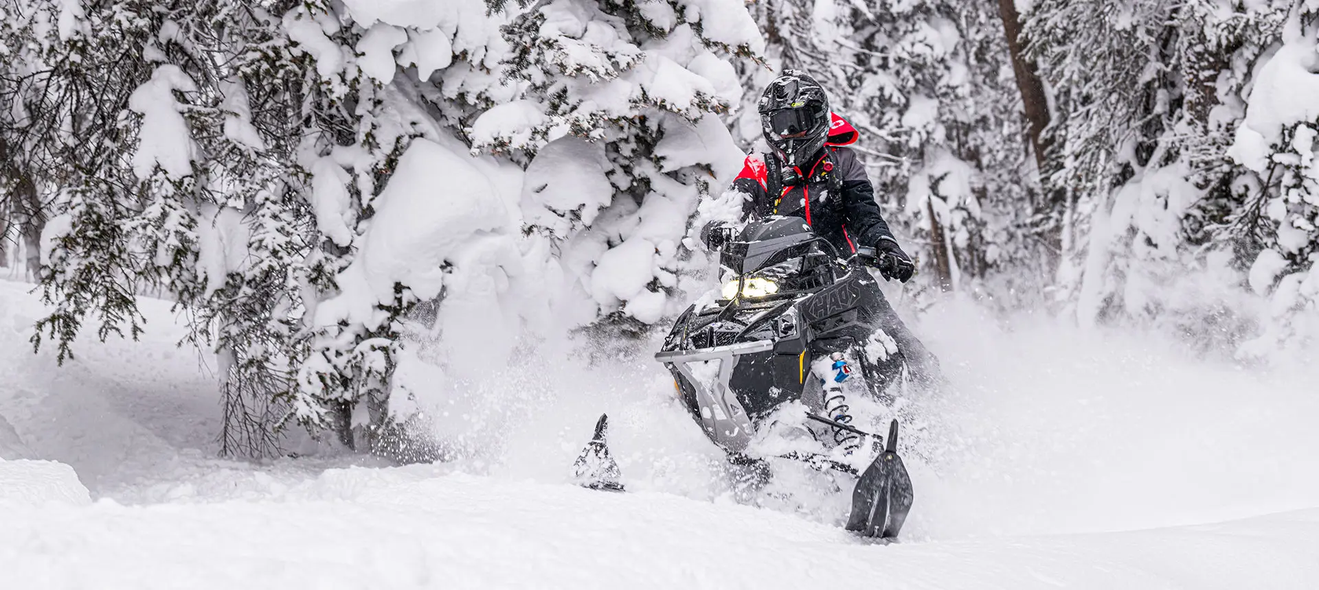 rider floating through deep snow on his polaris rmk khaos slash snowmobile