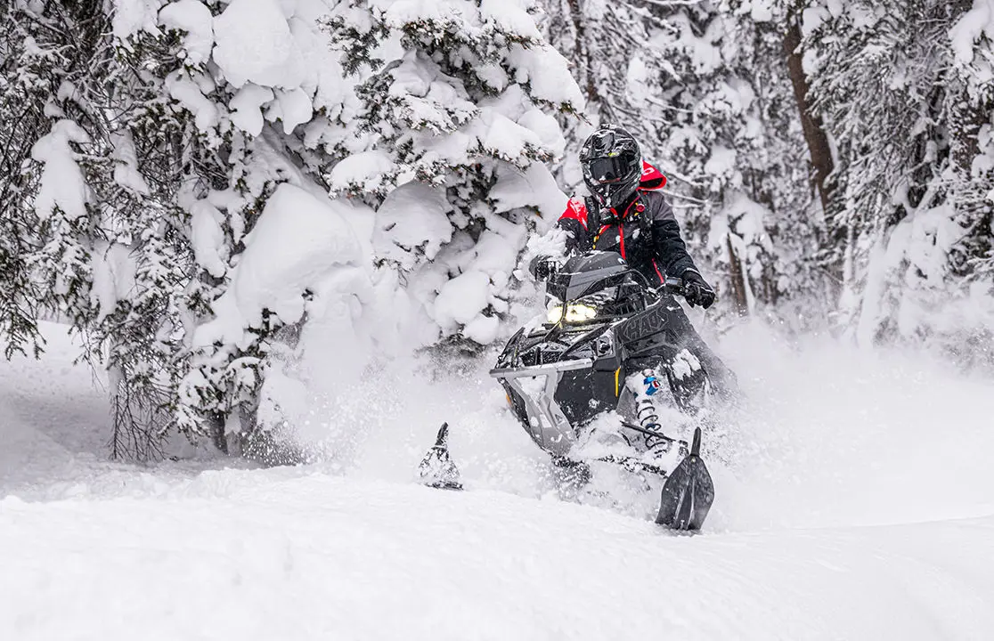 rider floating through deep snow on his polaris rmk khaos slash snowmobile
