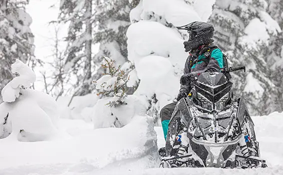 rider after a ride on their polaris rmk khaos slash snowmobile