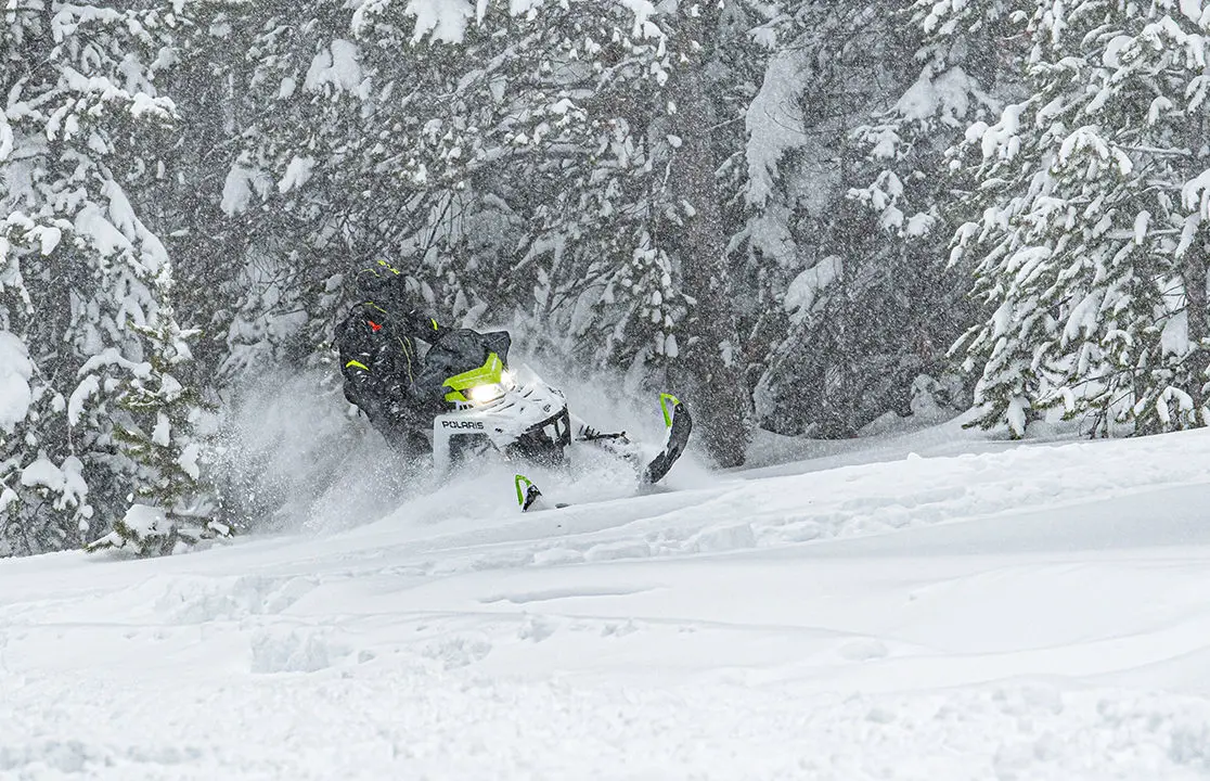 rider on a polaris sks 146 snowmobile