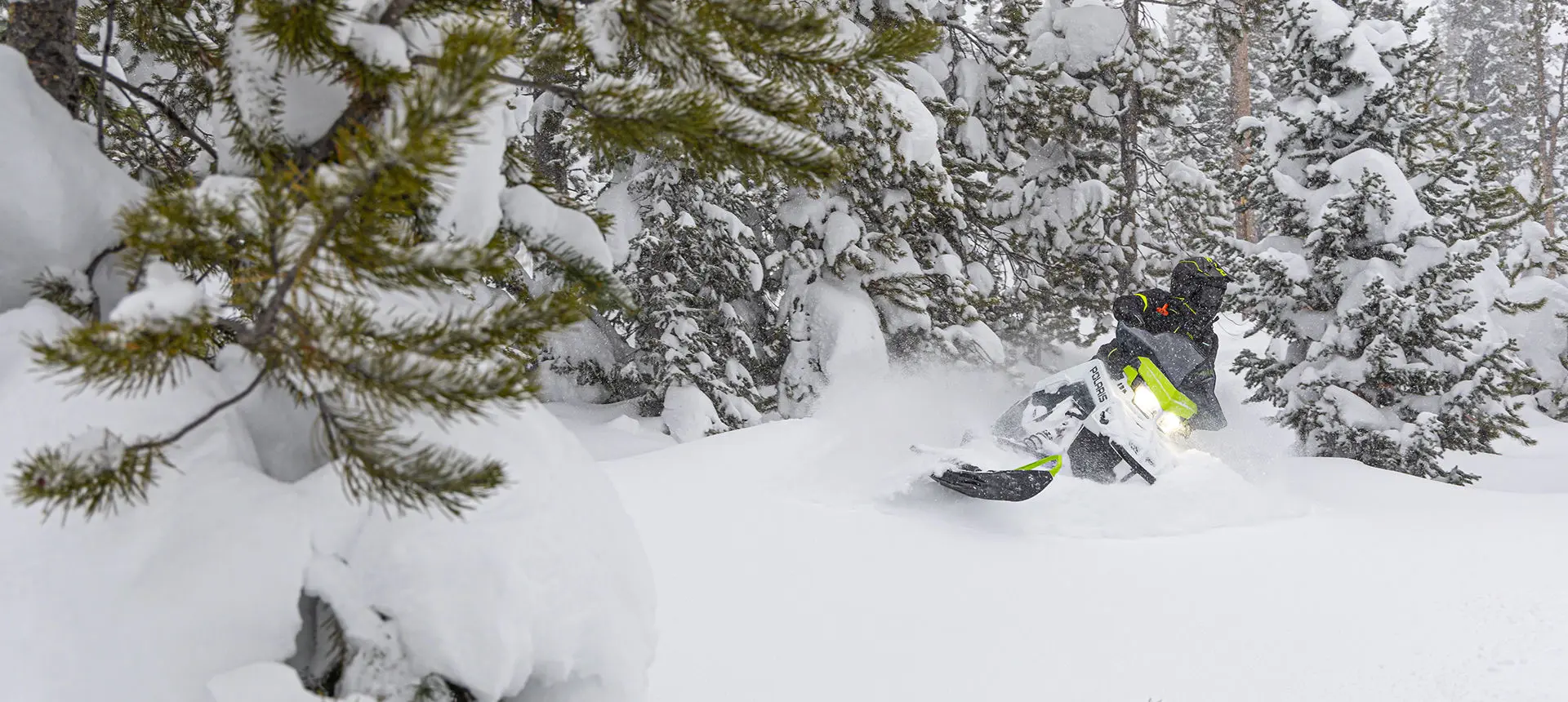 rider taking a swift turn on a polaris sks 146 snowmobile