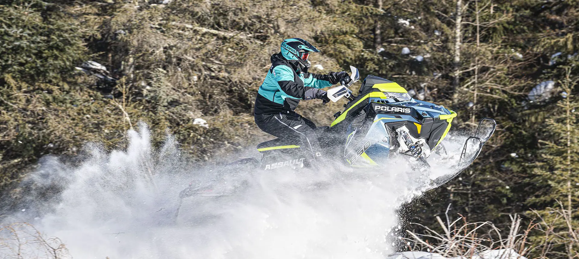 rider going airborne on a polaris switchback assault snowmobile