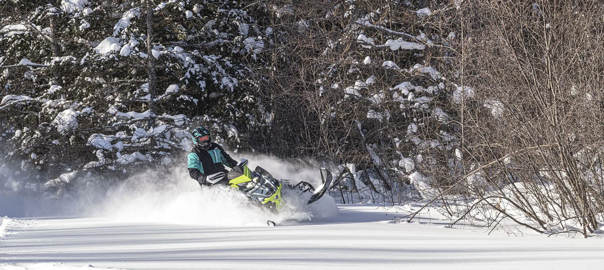 polaris switchback assault snowmobile taking a tight corner with ease