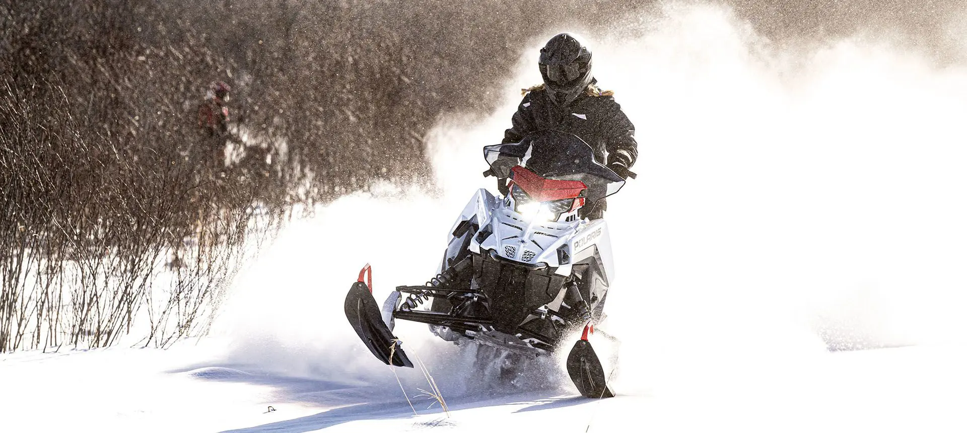 polaris switchback sp snowmobile cruising on a trail