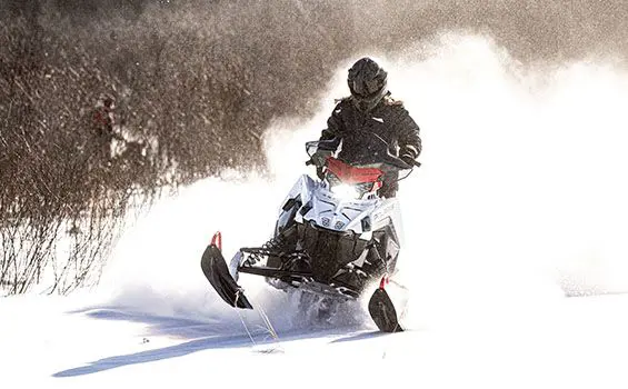 polaris switchback sp snowmobile cruising on a trail