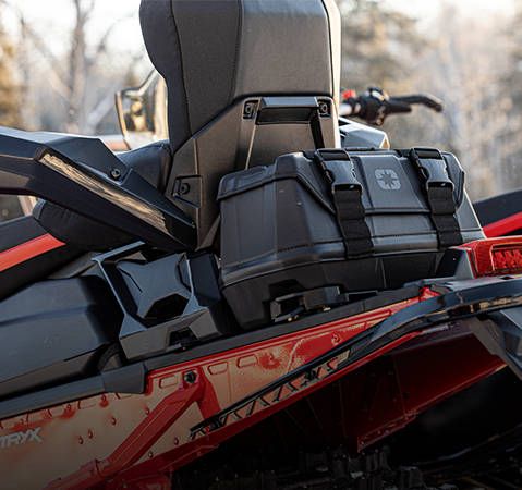 Strapped-on luggage accessory on the back of a Polaris Snowmobile. 
