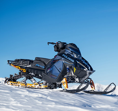 Limited edition Dream Orange Pearl & Matte Steel Blue paint with chrome decals colorway on the all-new 2026 Polaris PRO RMK Limited Edition mountain snowmobile.