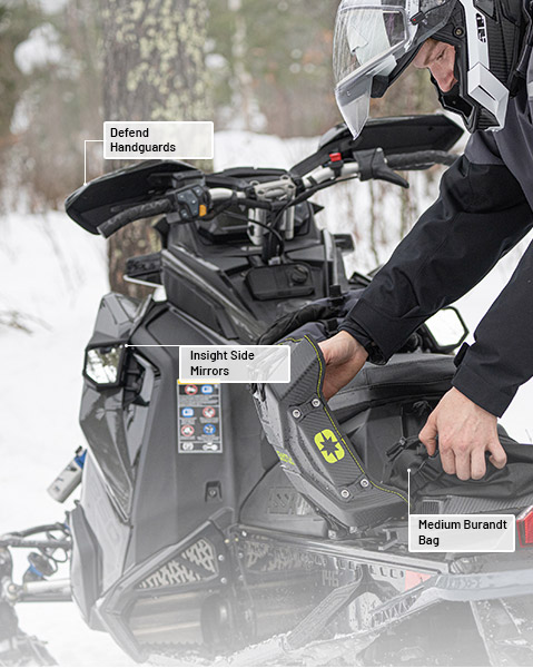 Insight Side Mirrors, Defend Handguards, and Medium Burandt Bag accessories from the Crossover Collection installed on a 2026 Polaris Switchback SP 146 snowmobile.