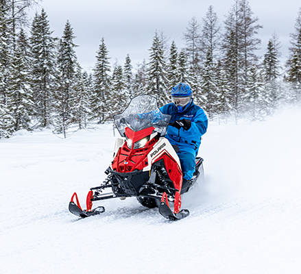 2 riders enjoying a trail ride on their 2027 Polaris INDY Adventure 2-up trail snowmobile.