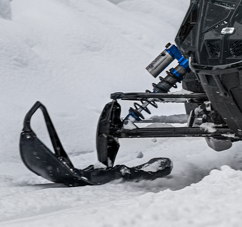Rider on a 2027 Polaris INDY VR1 trail sled showcasing the Walker Evans racing shocks.
