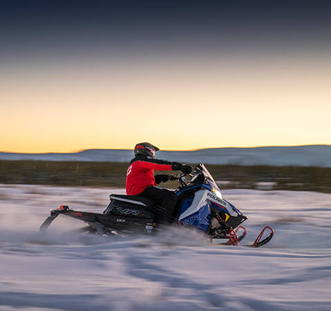 Rider on a 2027 Polaris INDY VR1 trail sled showcasing the rider-first ergonomics.
