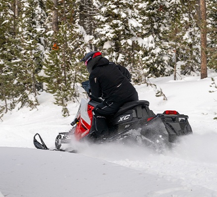 Rider on a 2027 Polaris INDY XC trail snowmobile showcasing the rider-first design.