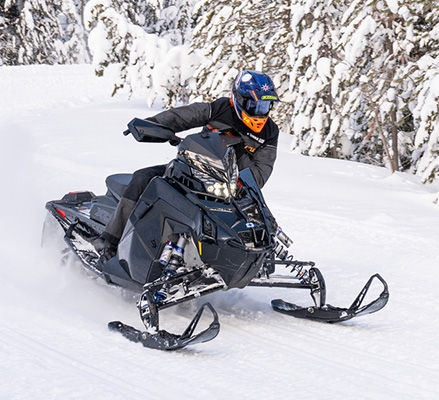 Rider on a 2027 Polaris INDY XCR snowmobile showcasing the rider-first ergonomics.