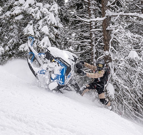 A rider showcasing the lightweight Matryx chassis on a 2027 Polaris Pro RMK mountain snowmobile.
