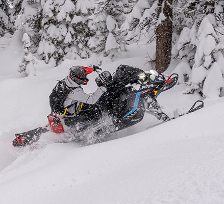 Rider showcasing the rigid chassis on a 2027 Polaris RMK Factory Edition mountain snowmobile.
