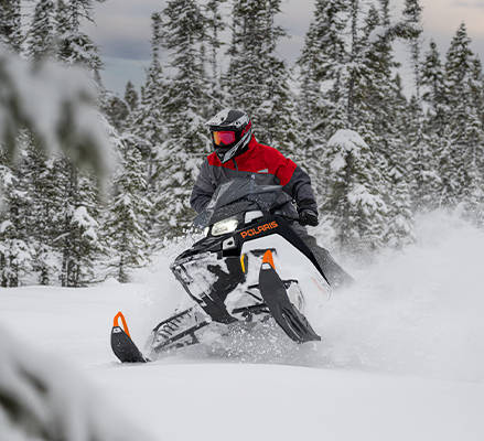 Rider on a 2027 Polaris Switchback SP snowmobile showcasing the Matryx Front Suspension.