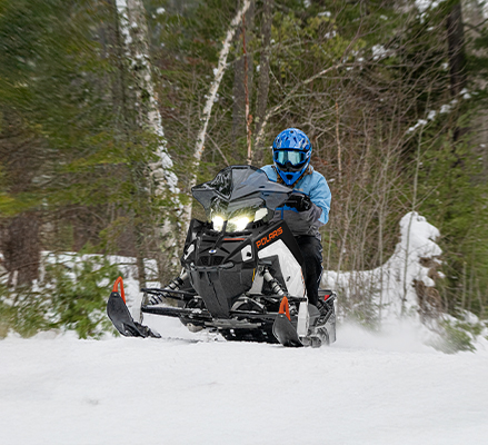 Rider on a 2027 Polaris Switchback SP snowmobile showcasing the IGX 146 Rear Suspension.