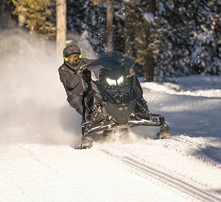 Rider showcasing the Matryx Front Suspension on a 2027 Polaris Switchback XC crossover snowmobile.