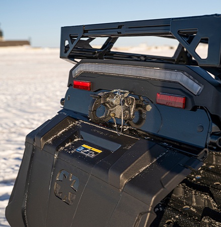 Rear end view of a 2027 TITAN Adventure widetrack snowmobile showcasing the standard tow hitch.