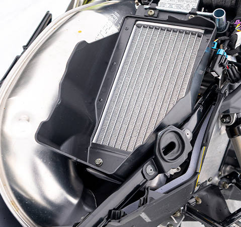 Underhood radiator on a 2027 Polaris Voyageur Adventure Ultimate sport-utility snowmobile.