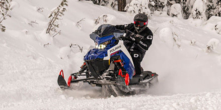 Rider on a Polaris snowmobile with DYNAMIX Suspension showcasing Rally Mode.
