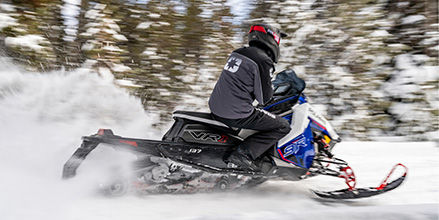 Rider on a Polaris snowmobile with DYNAMIX Suspension showcasing Extreme Mode.