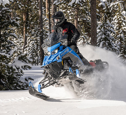 Rider cruising on a quick & efficient Polaris Snowmobile with the 650 Patriot engine.