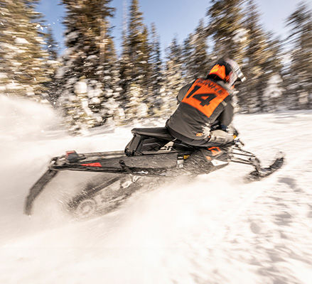 Rider on a lightweight Polaris Snowmobile with the 650 Patriot engine.