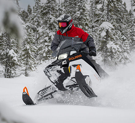 Rider showcasing the versatile performance of a Polaris Snowmobile with the 650 Patriot engine.