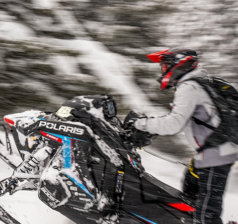 Rider on a Polaris Snowmobile with the Patriot 9R engine showcasing it's low inertia design.