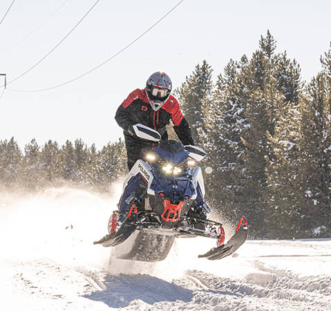 Rider showcasing the quick response of a 2027 Polaris snowmobile featuring the Patriot Boost engine. 
