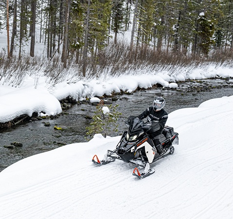 Rider cruising on a Polaris Snowmobile with the ProStar S4 4-stroke engine.