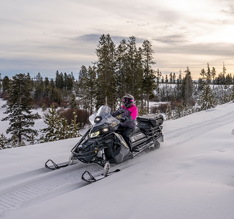 Rider taking a long, fuel-efficient ride on a Polaris Snowmobile with the ProStar S4 4-stroke engine.