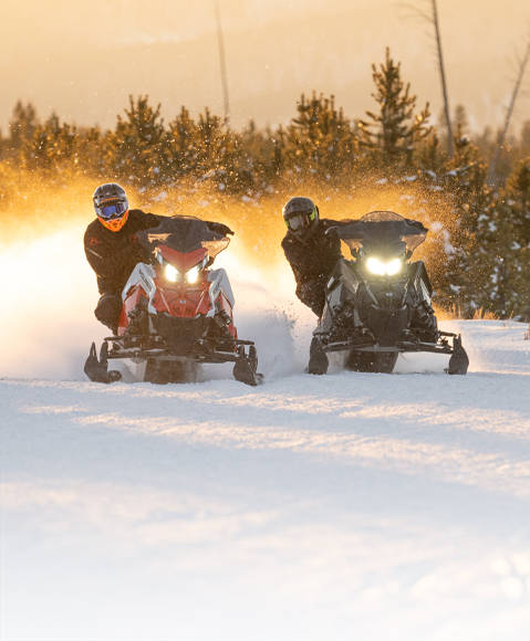 A rider trail-riding on their 2026 Polaris INDY trail snowmobile.