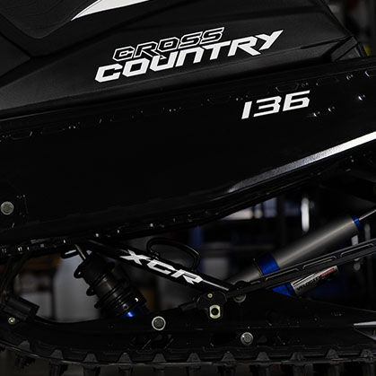 Close-up of the Polaris 600 INDY Cross Country rear suspension, black tunnel and 136-inch track.