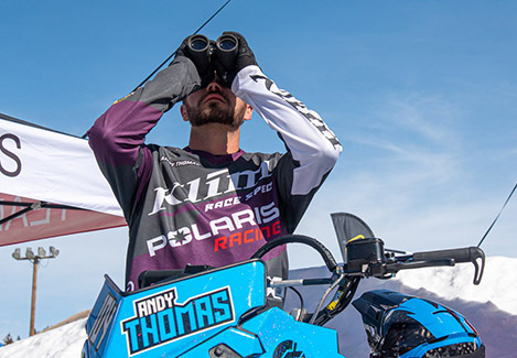 A Polaris Snowmobile Racer using binoculars