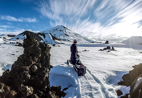 Polaris Snowmobile rider enjoying the winter blue sky