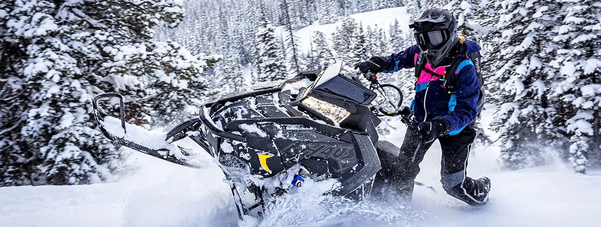 Shelley Balls riding a Snowmobile
