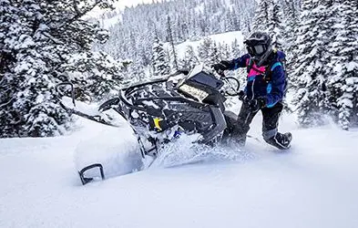Shelley Balls riding a Snowmobile