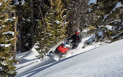 Gracie Gear riding a Snowmobile