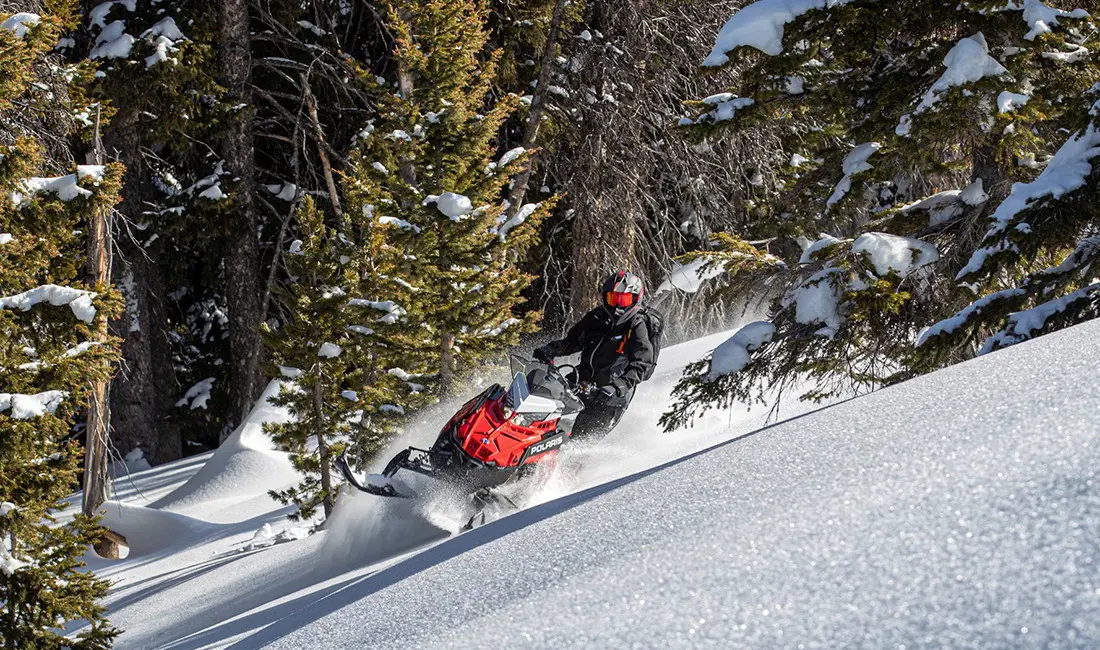 Gracie Gear riding a Snowmobile