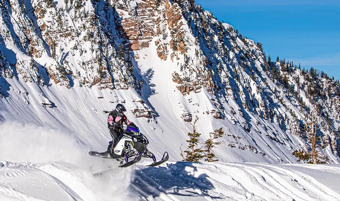 Gracie Gear riding a Snowmobile