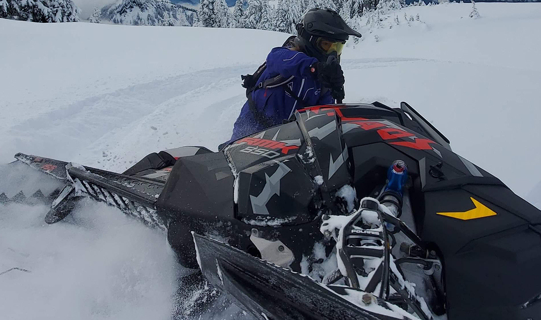 Hayley Alud riding a snowmobile