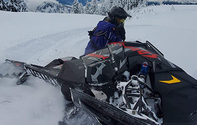 Hayley Alud riding a snowmobile