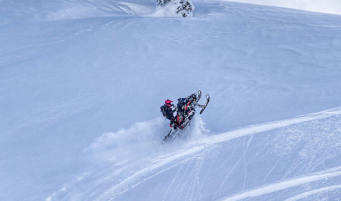 Sasha Bodie riding a snowmobile