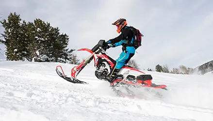 man riding a Polaris Timbersled sled, wearing polaris timbersled apparel and gear