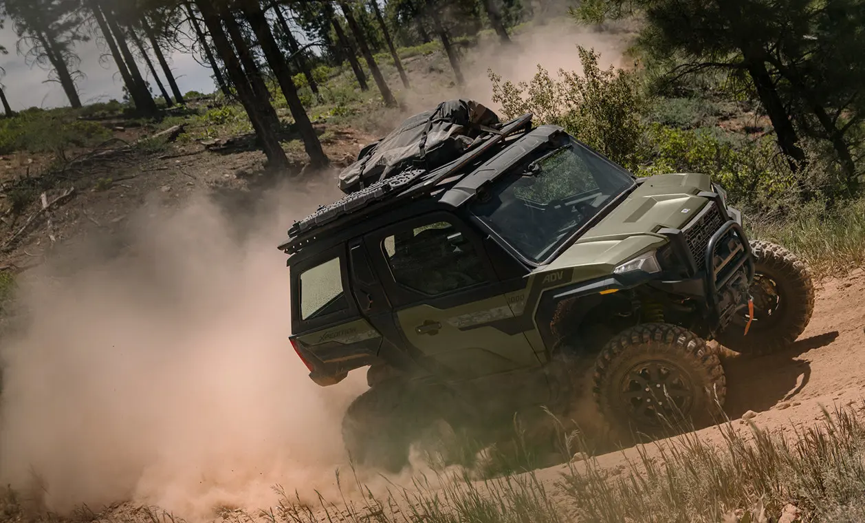 Autoquad Polaris XPEDITION ADV NorthStar 2025 remontant un sentier poussiéreux.